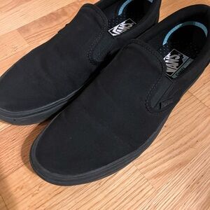 All black slip on vans